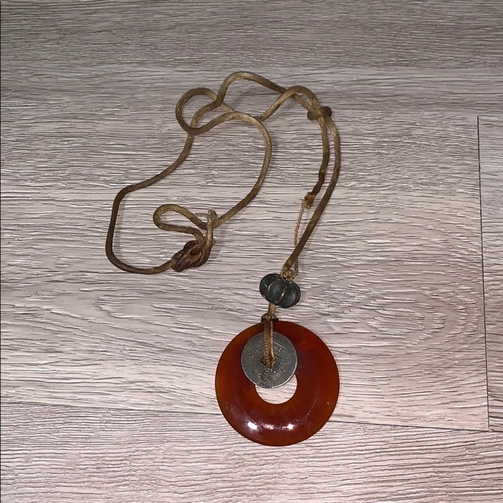 Amulet necklace with cash coin on leather rope